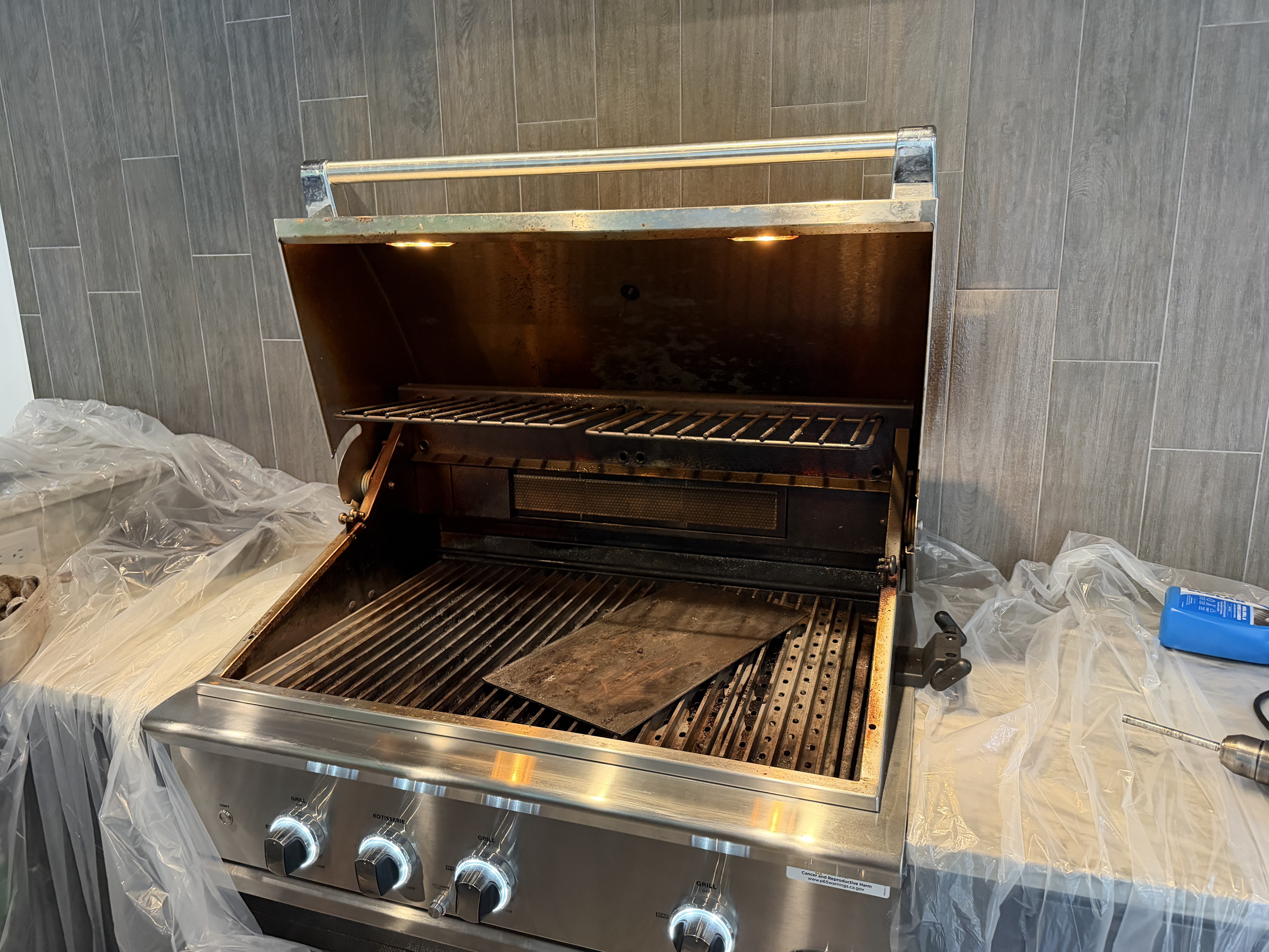 Before: DCS 4-burner built-in with grease buildup on the hood interior and soot on the back wall