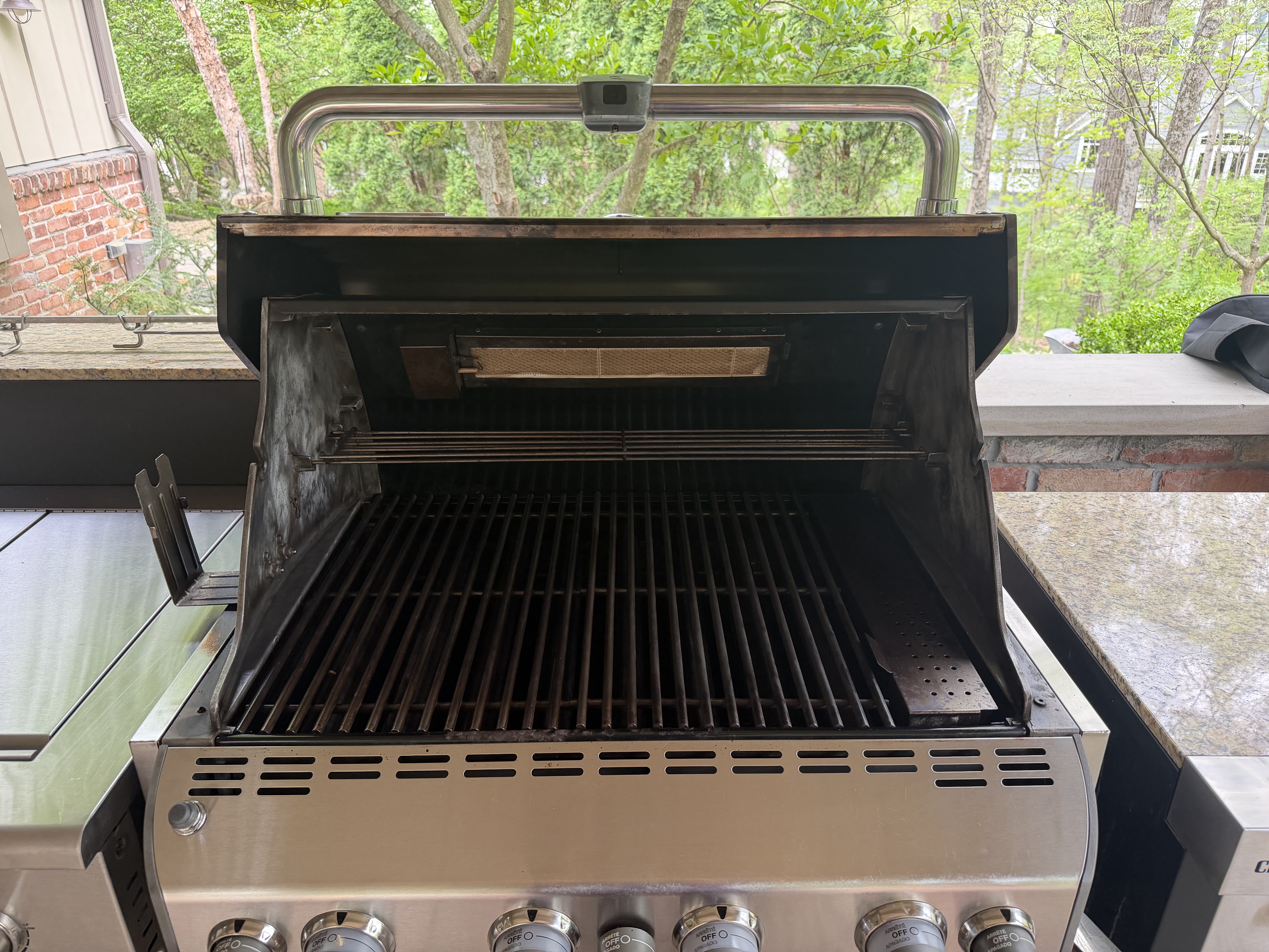 After: same 5-burner gas grill with a clean cookbox interior and fresh grates
