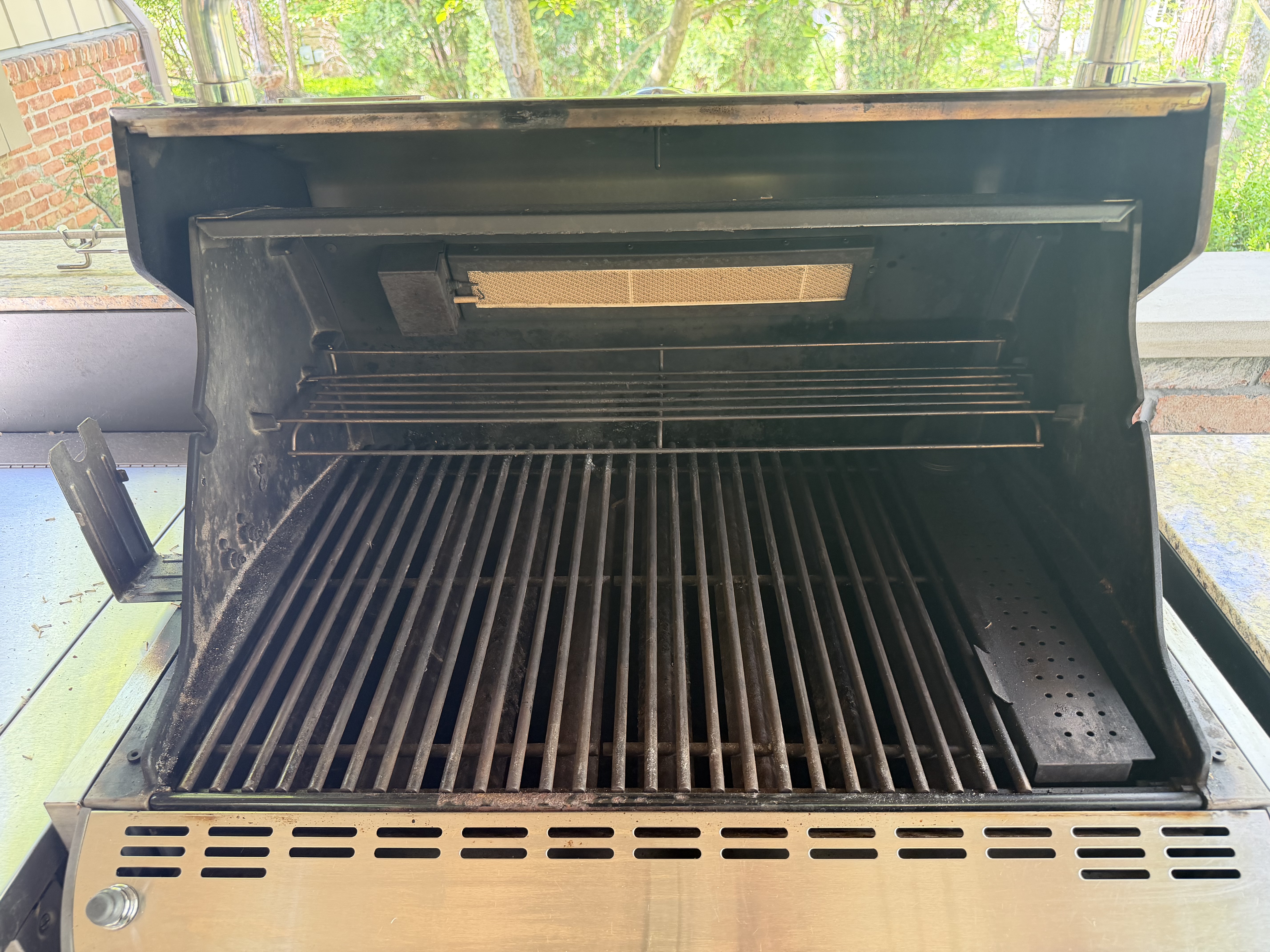 Before: 5-burner gas grill on a back patio with grease and soot across the cookbox and grates