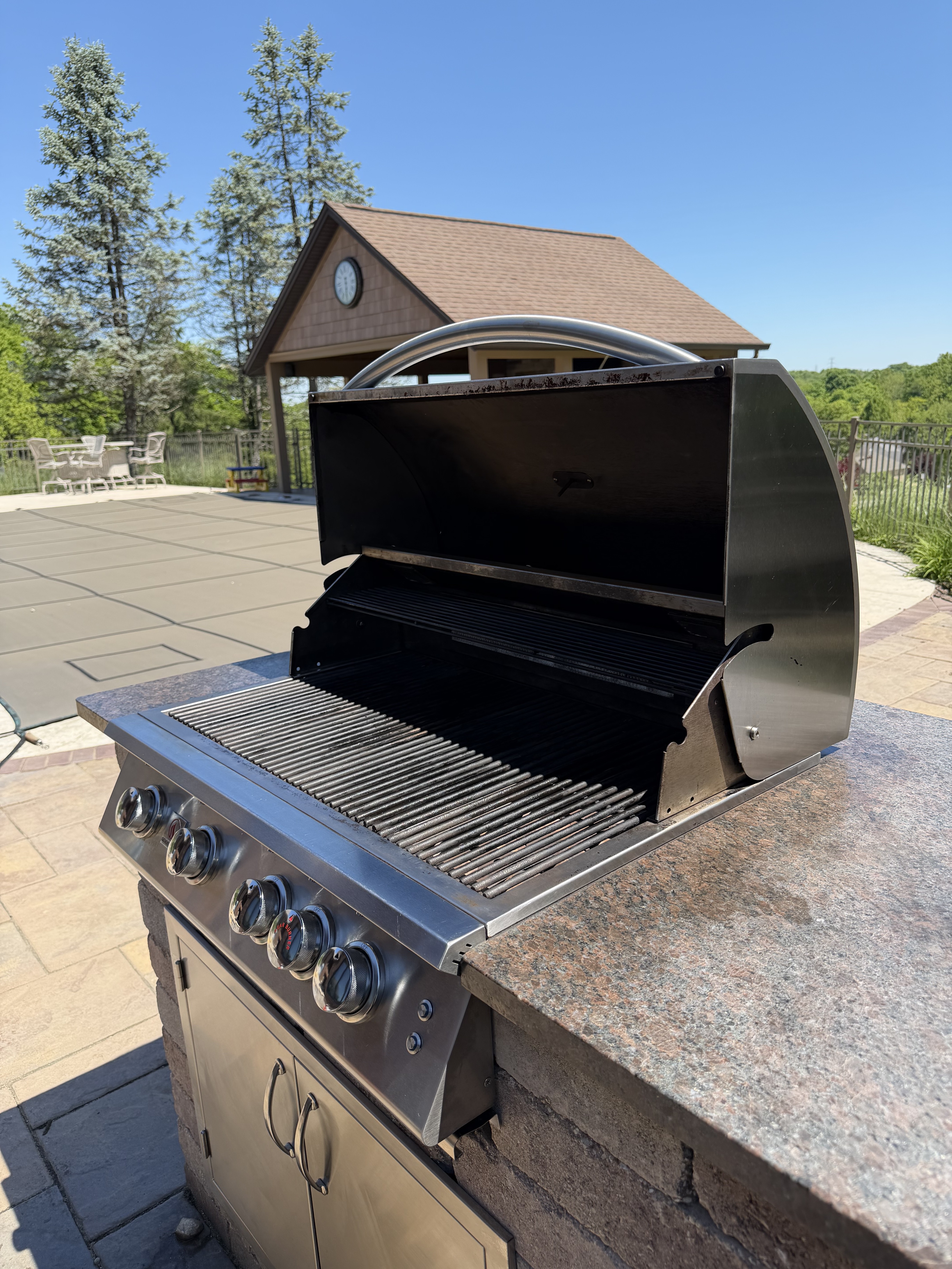 After: same 5-burner built-in grill with a clean polished cookbox and restored grates