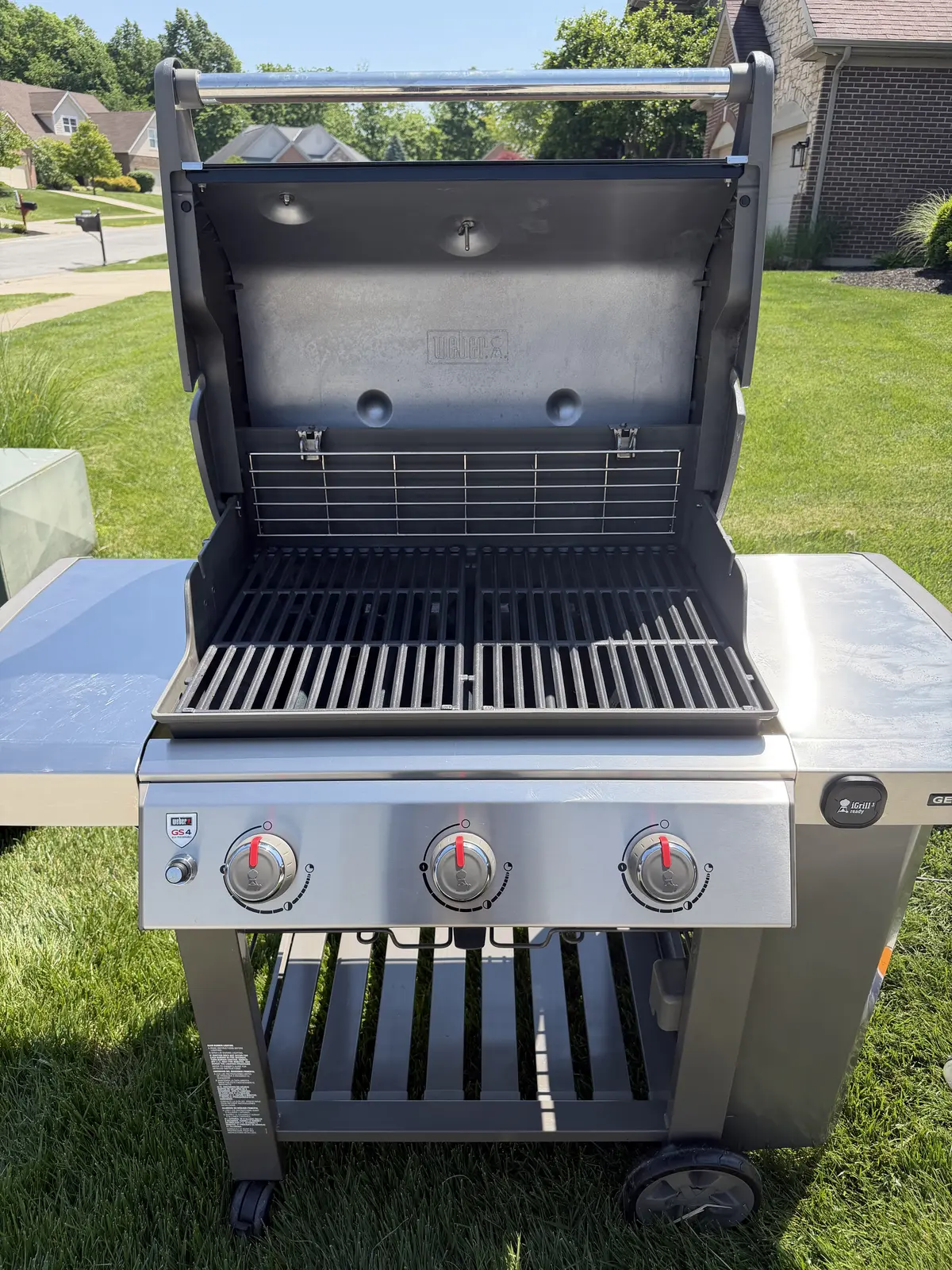 After: same Weber Genesis II 3-burner with clean grates reinstalled, a polished cookbox interior, and a clear control panel